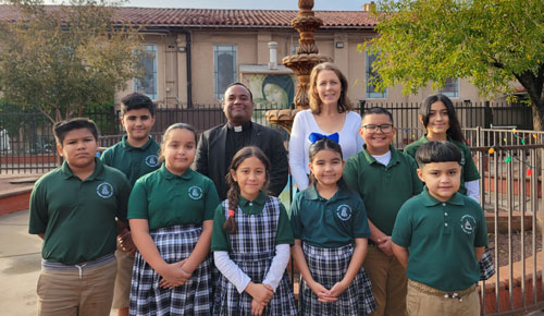 Photo with students, Fr. Nelson and Principal Tax